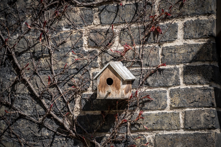 Wooden birdhouse  mounted on brick wall.の写真素材