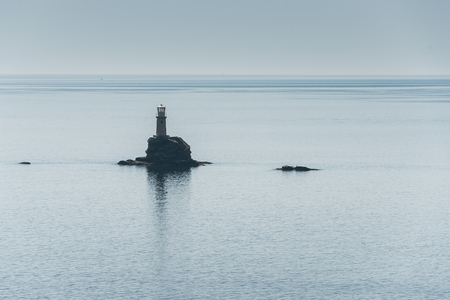 Lighthouse on lone rock in the Mediterranean Seaの写真素材