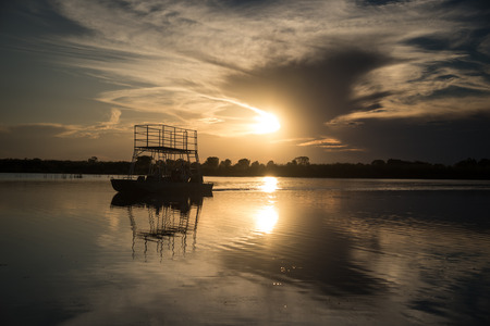 Sunset over the water on the Okavango Delta Botswanaの写真素材
