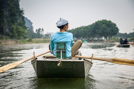 Rowing traditional bamboo boats in Tam Coc Ninh Binh Vietmanのeditorial素材