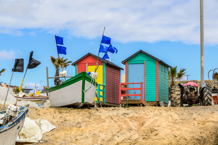 Fishing boats and brightly coloured beach shacks in Huelva spain.の写真素材