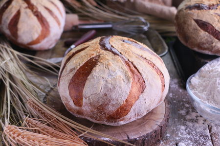 Fresh Artisan Sour Dough Bread on old rustic kitchen table.