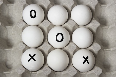 Beginning of the game. Drawing on eggs - tic-tac-toe gameの写真素材