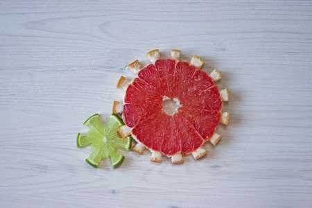 Gear drive made of citrus slices on wooden backgroundの写真素材
