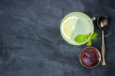 Cup of Ginger tea with lemon and honey on dark background, top viewの写真素材
