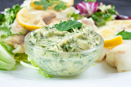 fresh homemade tartar sauce with steamed fish and parsleyの写真素材