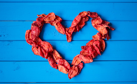 background with heartshape of sun dried tomato. top viewの写真素材