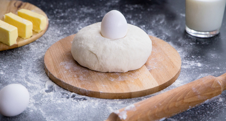 fresh dough ready for baking with ingredientsの写真素材
