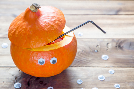 cocktail in a decorated pumpkin. halloween drinks for party. festive conceptの写真素材