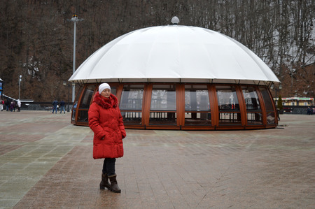A woman stands near the pavilion on the square mountain resortの写真素材