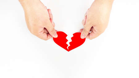 Both hands picked up the red heart pieces. That is split into twoの写真素材