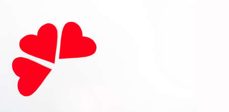 Three red paper hearts On a white backgroundの写真素材
