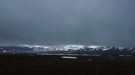 A view from backcountry mountain road F35 in interior highlands of Iceland towards Hofsjokull glacier with very low clouds.の写真素材