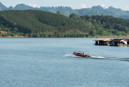 Boat tour and tourist travel in the lake of Kanchanaburi, Thailand.