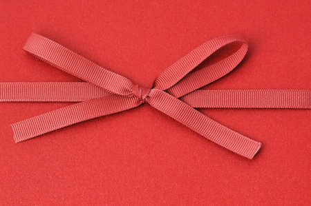 Red ribbon on red background 