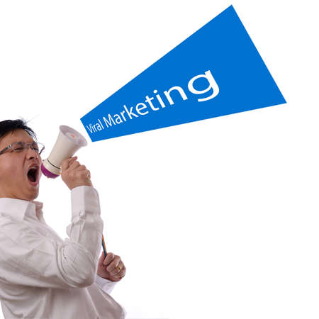 Portrait of an asian businessman using a megaphone for viral marketing design conceptの写真素材