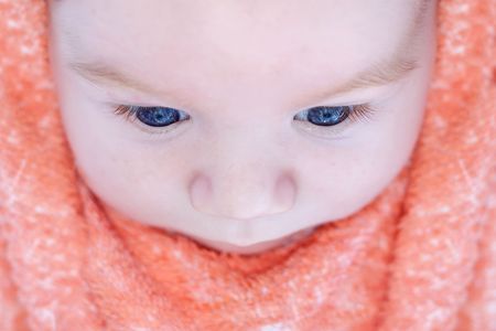 Top view of a beautiful cute baby with big blue eyes and long eyelashesの写真素材