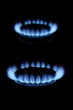 Blue gas flames burning on black background