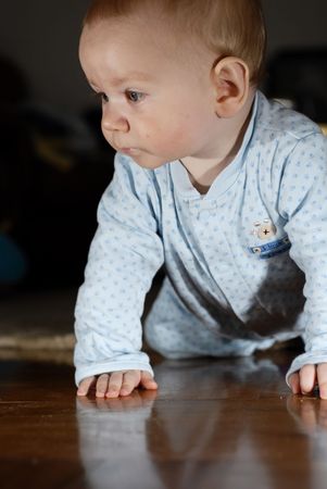 Beautiful baby boy crawling around on his kneesの写真素材