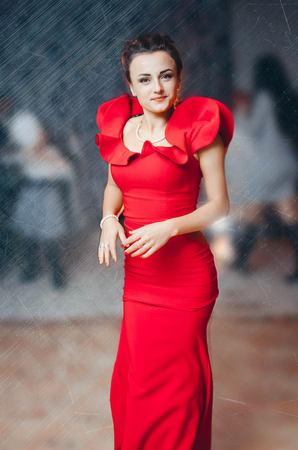 beautiful elegant girl in red dressの写真素材