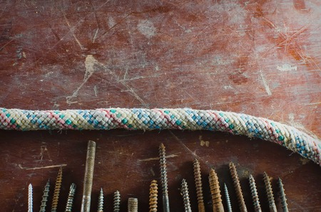 Texture, grunge, background, screws and rope to lie on the table, vertically