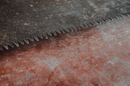 a hacksaw on the old table background texture liesの写真素材