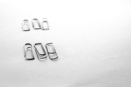 Paperclips scattered on a white background stationery metal office in a different orderの写真素材