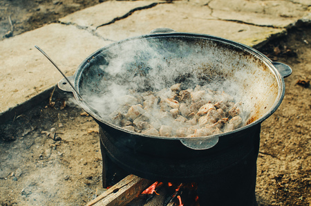 The cauldron on the fire street food cooking pilaf, meat picnics holidaysの写真素材