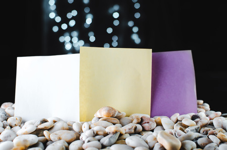The stickers stick out in pebbles on a black background, bokeh lightsの写真素材