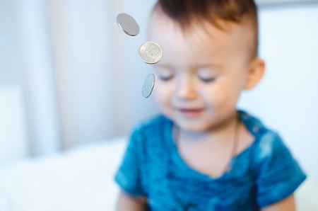 The child with the coins in the foreground with closedの写真素材