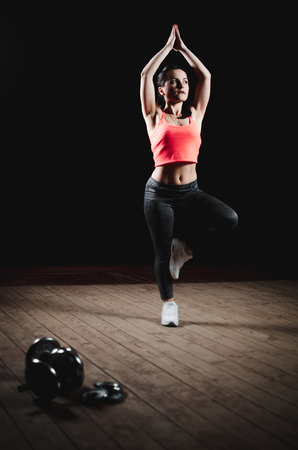 Girl in t-shirt stands and doing exerciseの写真素材