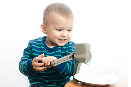 Child Melita sugar into powder in a coffee grinderの写真素材