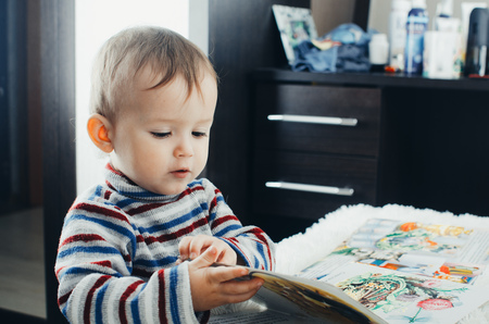 The child looks the book is very passionate about his occupation, likeの写真素材