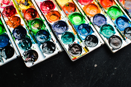 Paint lay on the black surface, pretty lights background, creativityの写真素材