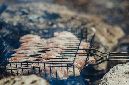 skewers of chicken in grid on charcoal friedの写真素材