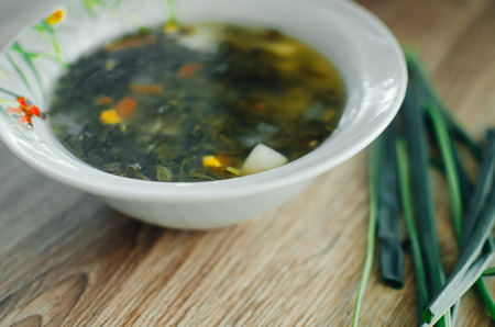 Soup with sorrel on wooden table in rustic styleの写真素材