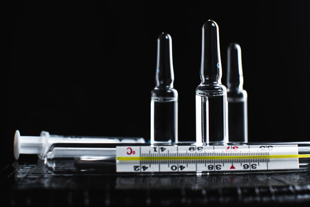 On the table there are ampoules, next different pills,drugs and medicationsの写真素材