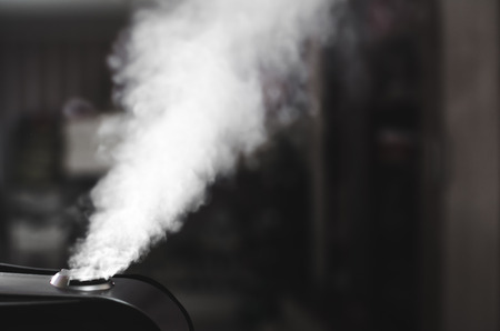 The steam from the humidifier at night in the dark black