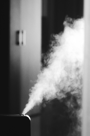 The steam from the humidifier at night in the dark black