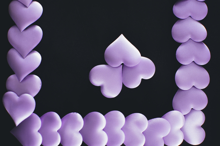 Many purple hearts in the form of frames and space for lettering designersの写真素材