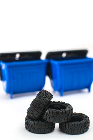 Near garbage containers on a white background are folded tires from the vehicleの写真素材