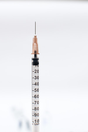 Plastic syringe insulin with needle on white backgroundの写真素材