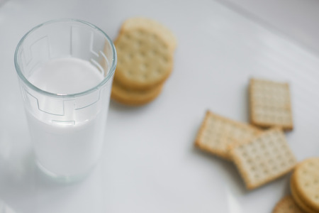 miscellaneous cookies, next to milk on a soft light background, homemade, rustic with light from the windowの写真素材