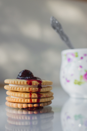 cookies with filling next with a glass of milk nicely at home, on top of the jamの写真素材