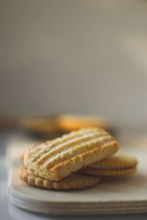 miscellaneous cookies, next to milk on a soft light background, homemade, rustic with light from the windowの写真素材