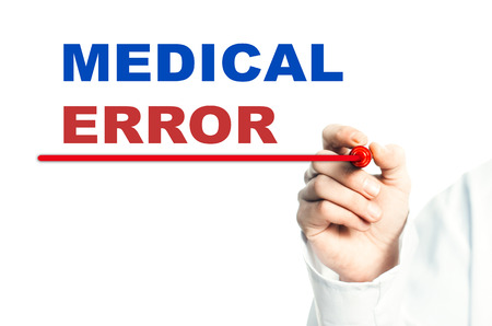 Hand draws a red line marker, emphasizes the important inscription medical MEDICAL ERRORの写真素材