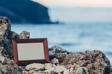 Photo frame stone, sea at sunset place for lettering, copyspace