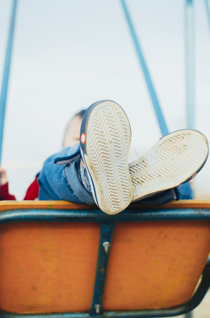 Little baby swinging on the swing and not afraidの写真素材