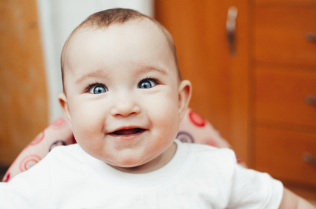 portrait of a baby charming cheerful girl in a Walker largeの写真素材