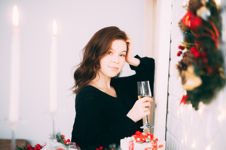 Beautiful girl with a glass of champagne, Christmas atmosphere, new yearの写真素材